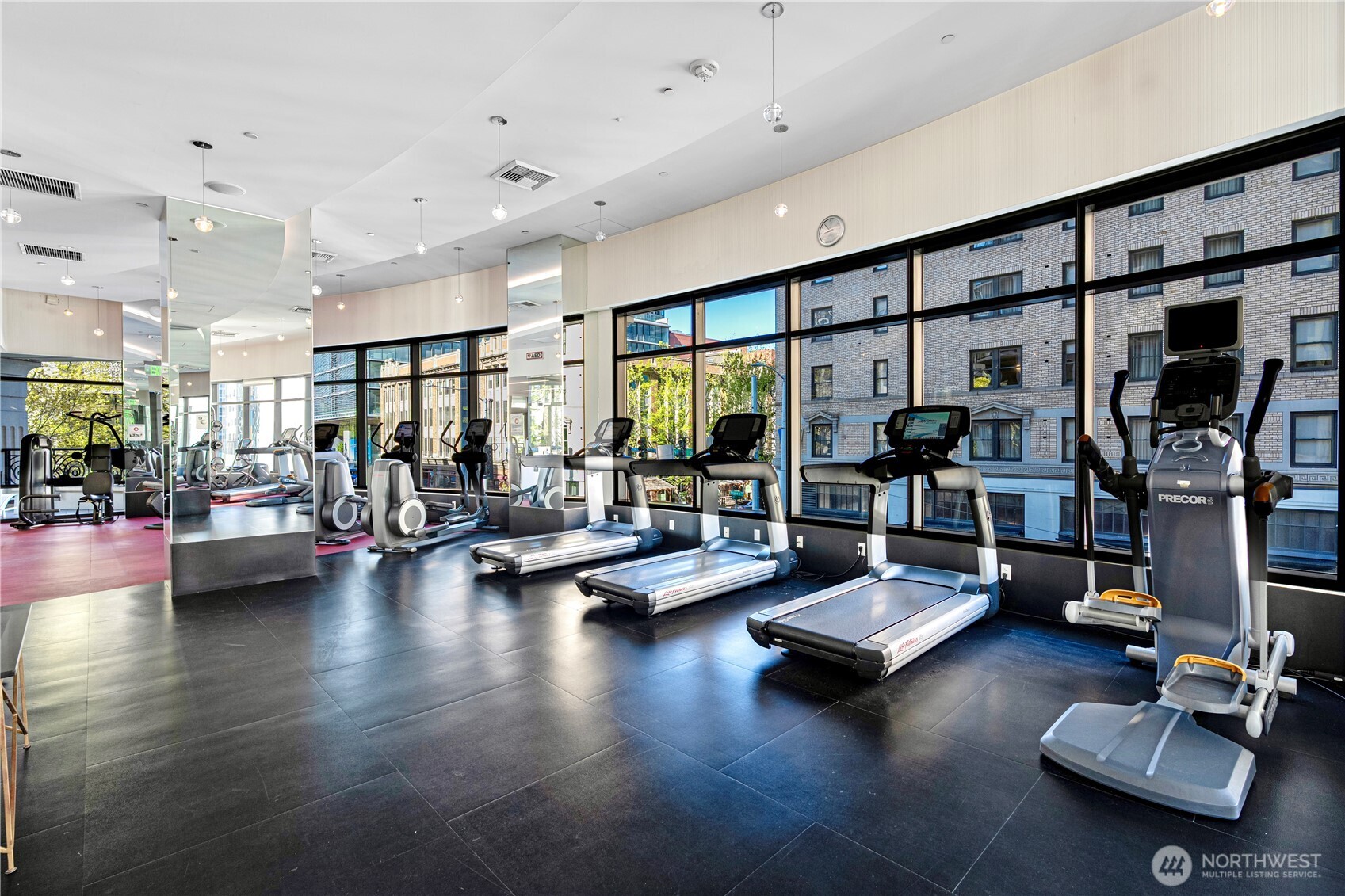 1920 4th Avenue, Unit 1809 Seattle, WA 98101 - Photo 22 of 30 a living room with furniture gym equipment and a large window