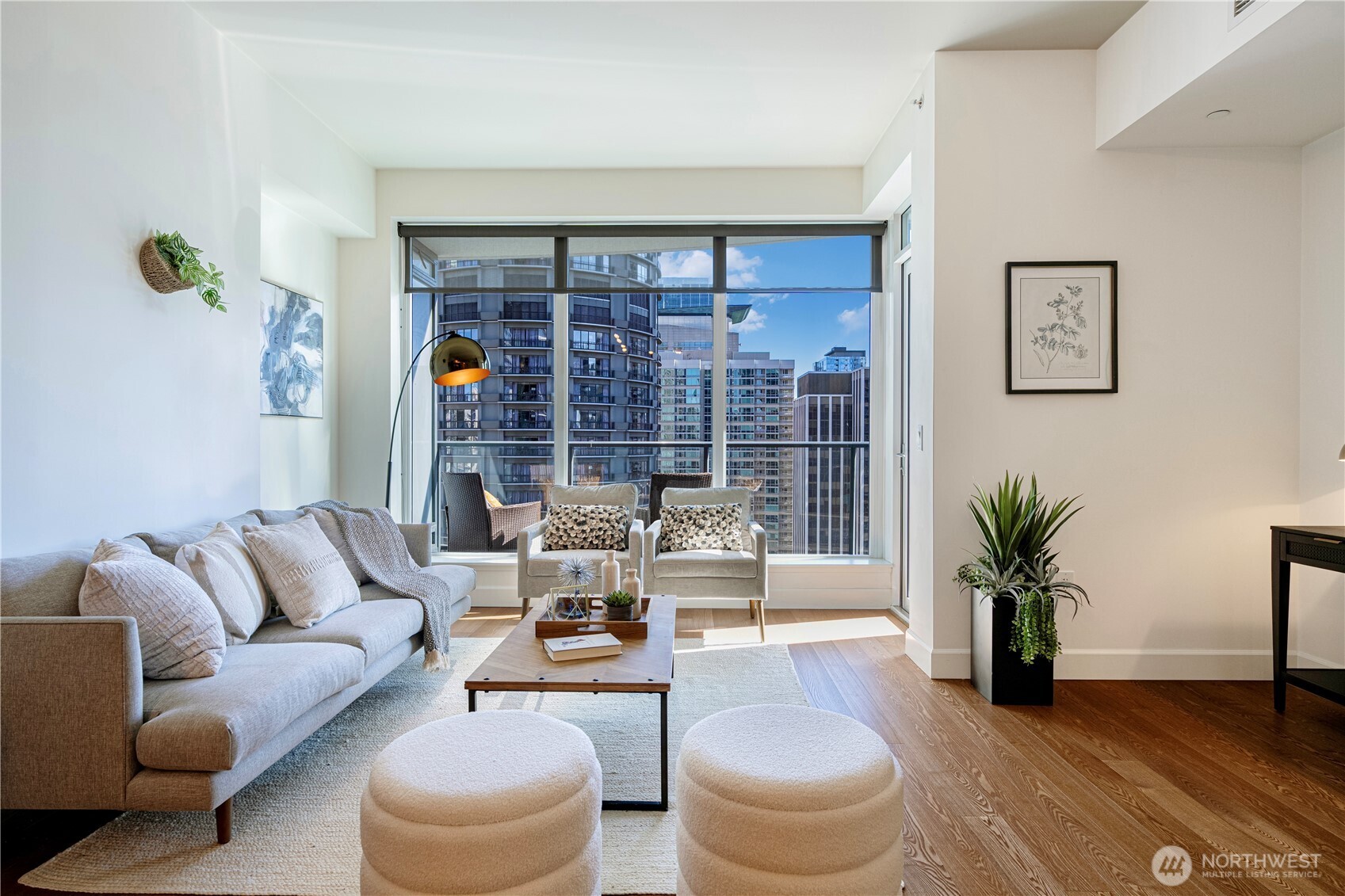 1920 4th Avenue, Unit 1809 Seattle, WA 98101 - Photo 5 of 30 a living room with furniture and a potted plant