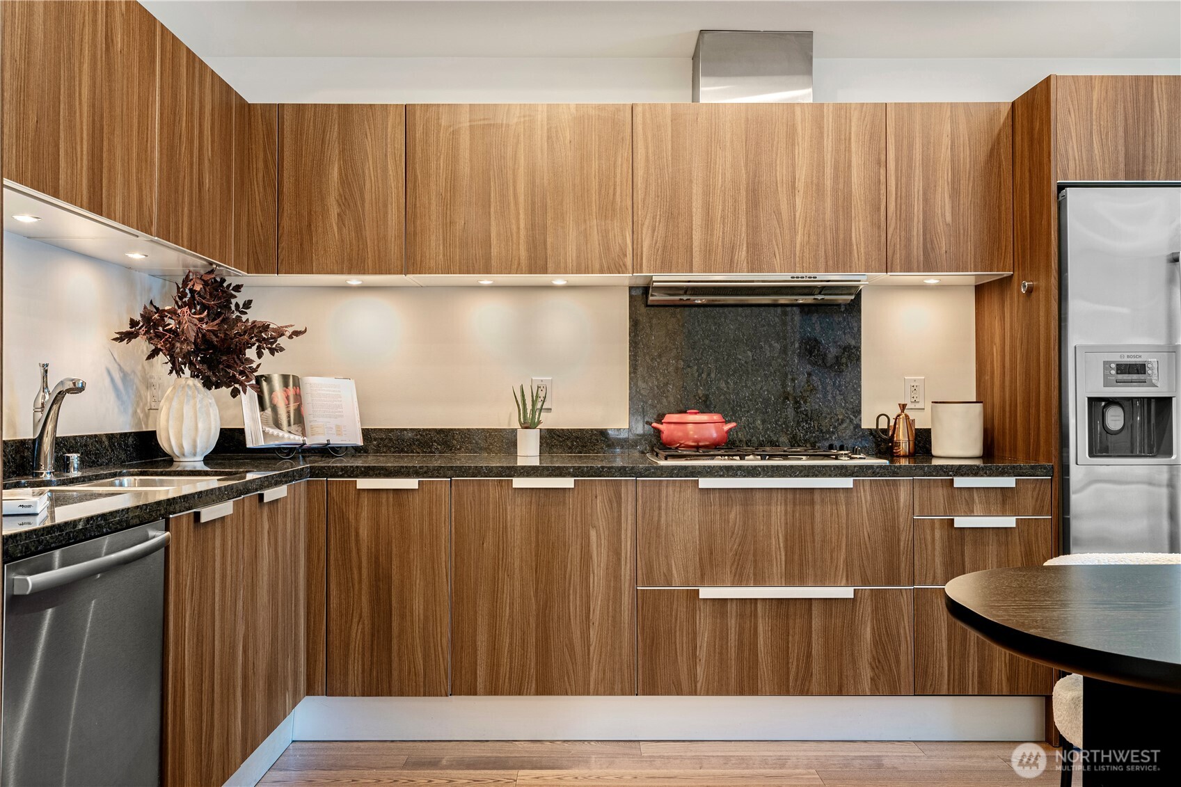 1920 4th Avenue, Unit 1809 Seattle, WA 98101 - Photo 7 of 30 a kitchen with a sink refrigerator and cabinets