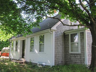 front view of a house with a tree