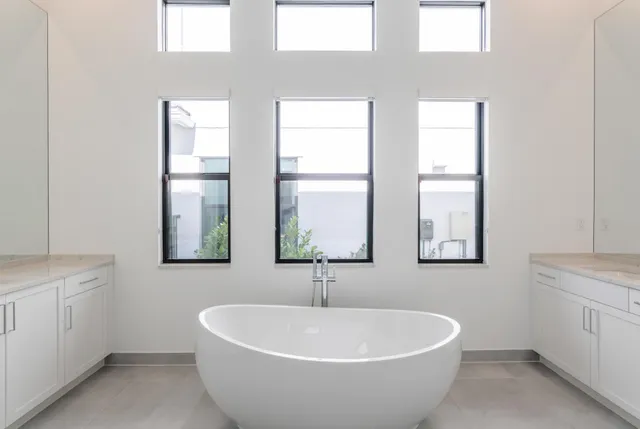 a white bath tub sitting next to a white sink