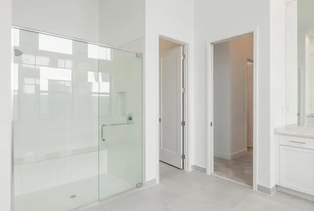 a bathroom with a glass shower door