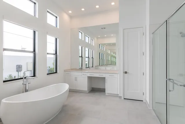 a large spacious bathroom with a double vanity sink a mirror and a bathtub