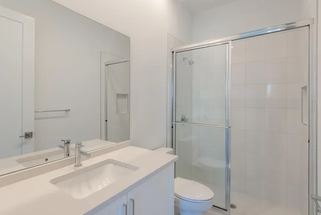 a bathroom with a sink toilet and shower