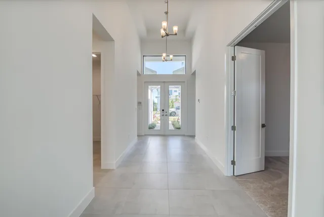 a view of a hallway with wooden floor and a bathroom