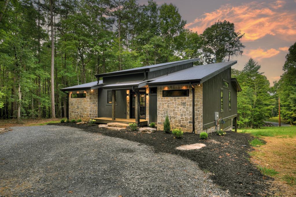 2596 Hwy 2 Blue Ridge Blue Ridge, GA 30513 - Photo 1 of 56 a front view of a house with garden