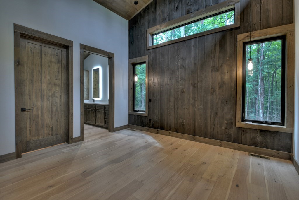 2596 Hwy 2 Blue Ridge Blue Ridge, GA 30513 - Photo 23 of 56 an empty room with wooden floor and windows