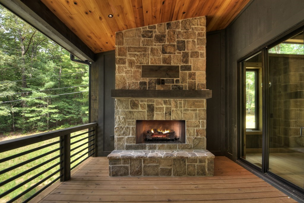 2596 Hwy 2 Blue Ridge Blue Ridge, GA 30513 - Photo 29 of 56 a living room with a fireplace and a floor to ceiling window