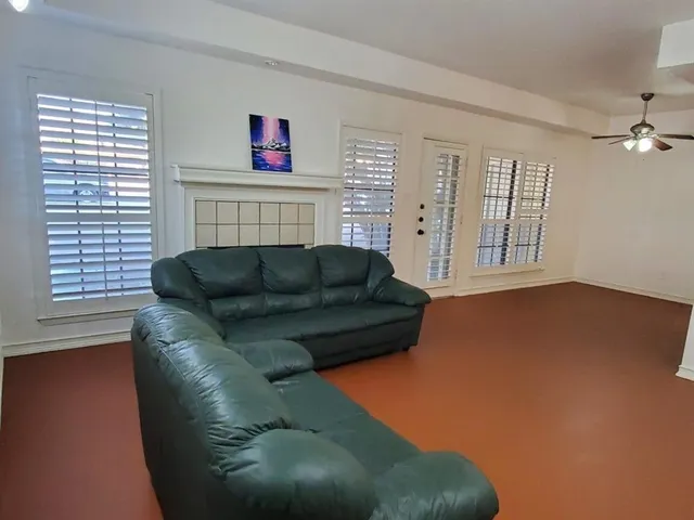 a living room with furniture a fireplace and a window