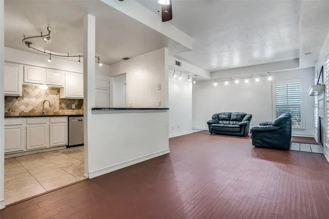a open kitchen with refrigerator stove and wooden floor