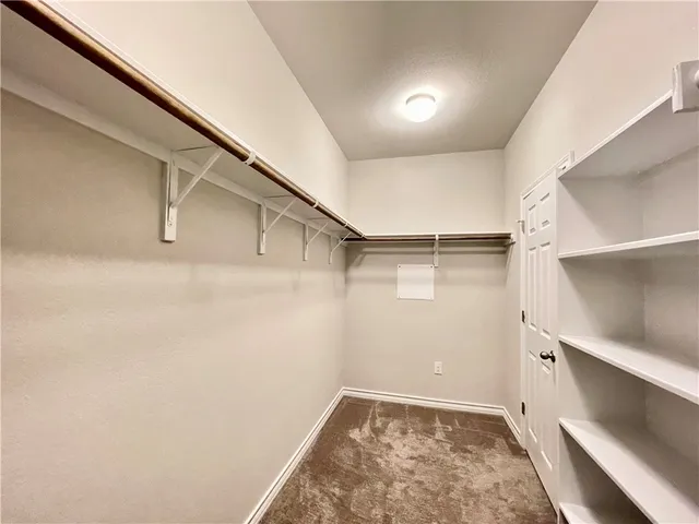 a view of an empty walk in closet