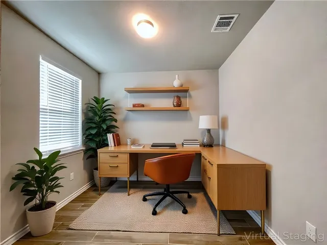 a workspace with furniture and potted plant