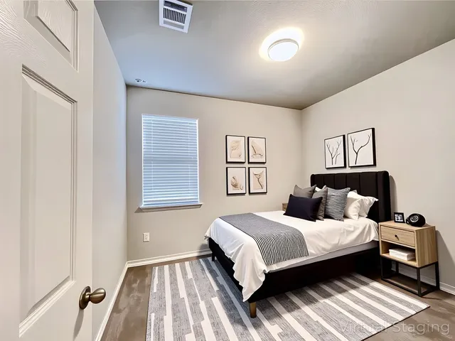 a bedroom with a bed and a night stand