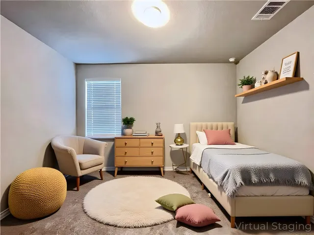 a bedroom with bed and a chair