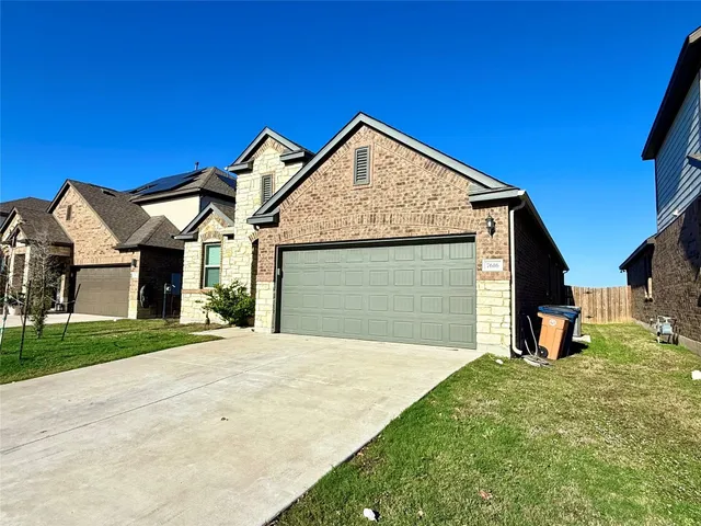 a view of a house with a yard and garage