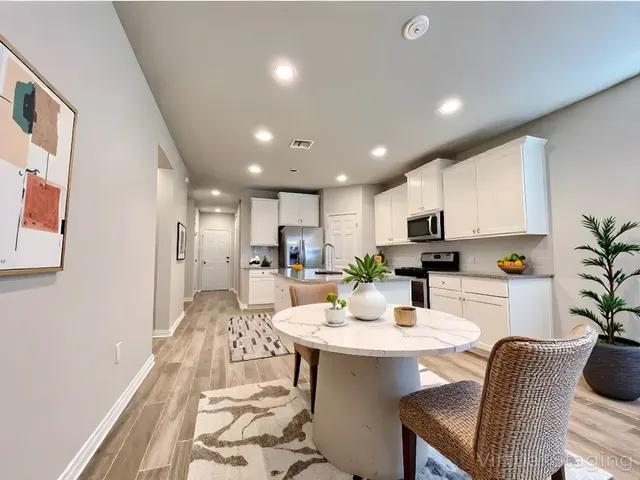 a kitchen with a table and chairs