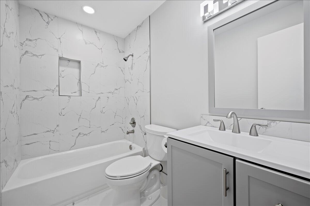 196 Raintree Trail Jupiter, FL 33458 - Photo 15 of 26 a bathroom with a sink toilet vanity and shower