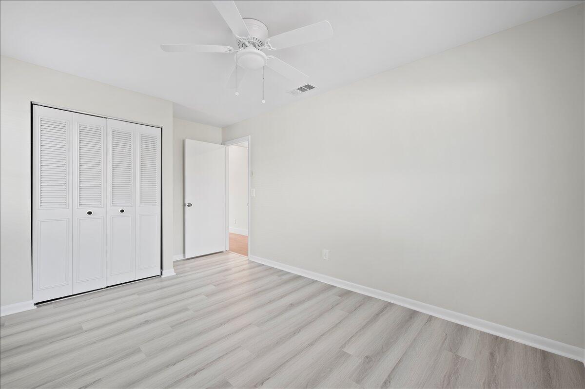 196 Raintree Trail Jupiter, FL 33458 - Photo 17 of 26 a view of an empty room with wooden floor