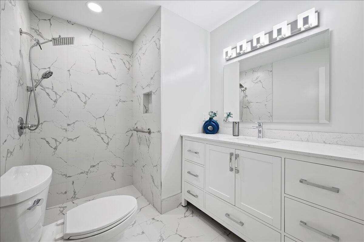 196 Raintree Trail Jupiter, FL 33458 - Photo 18 of 26 a bathroom with a sink a toilet and shower