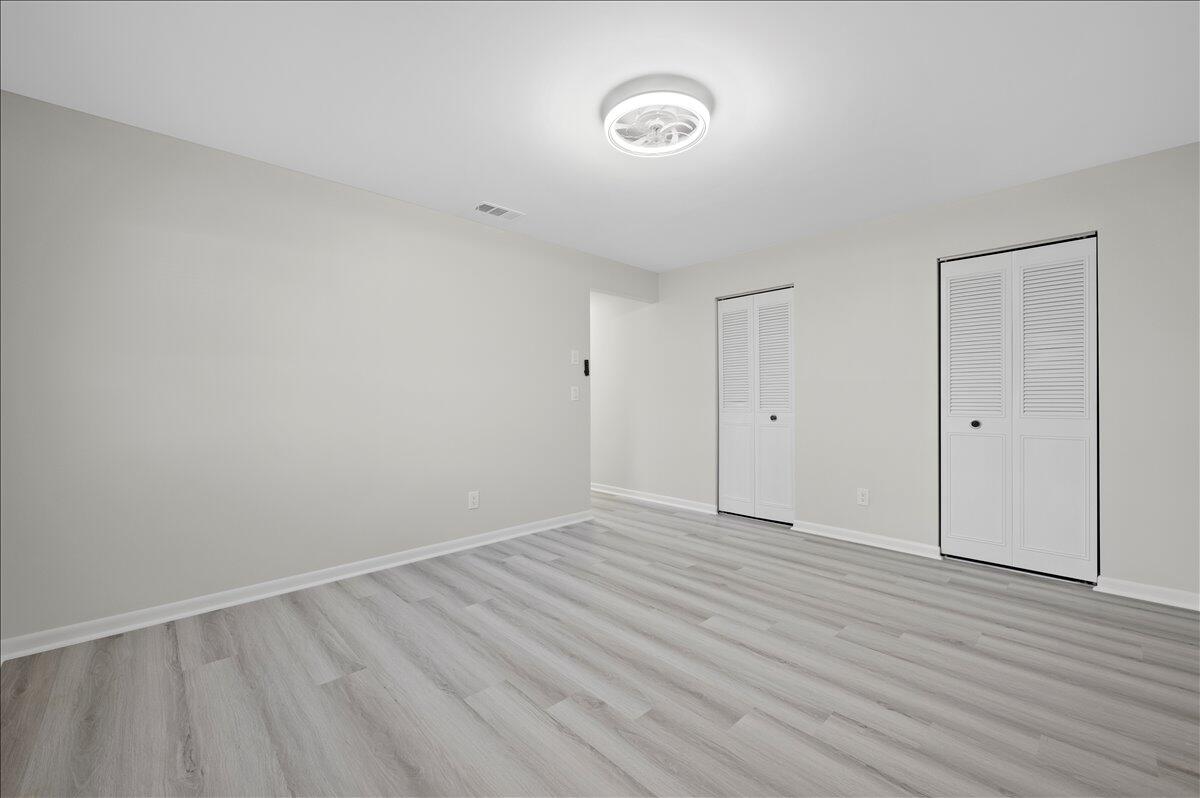 196 Raintree Trail Jupiter, FL 33458 - Photo 21 of 26 a view of an empty room with wooden floor