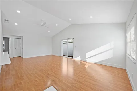 a view of an empty room with wooden floor