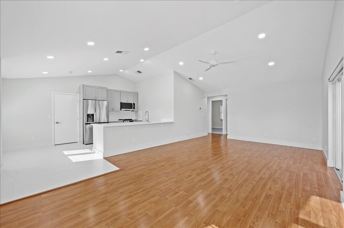 196 Raintree Trail Jupiter, FL 33458 - Photo 4 of 26 a view of kitchen with kitchen island wooden floor appliances and cabinets