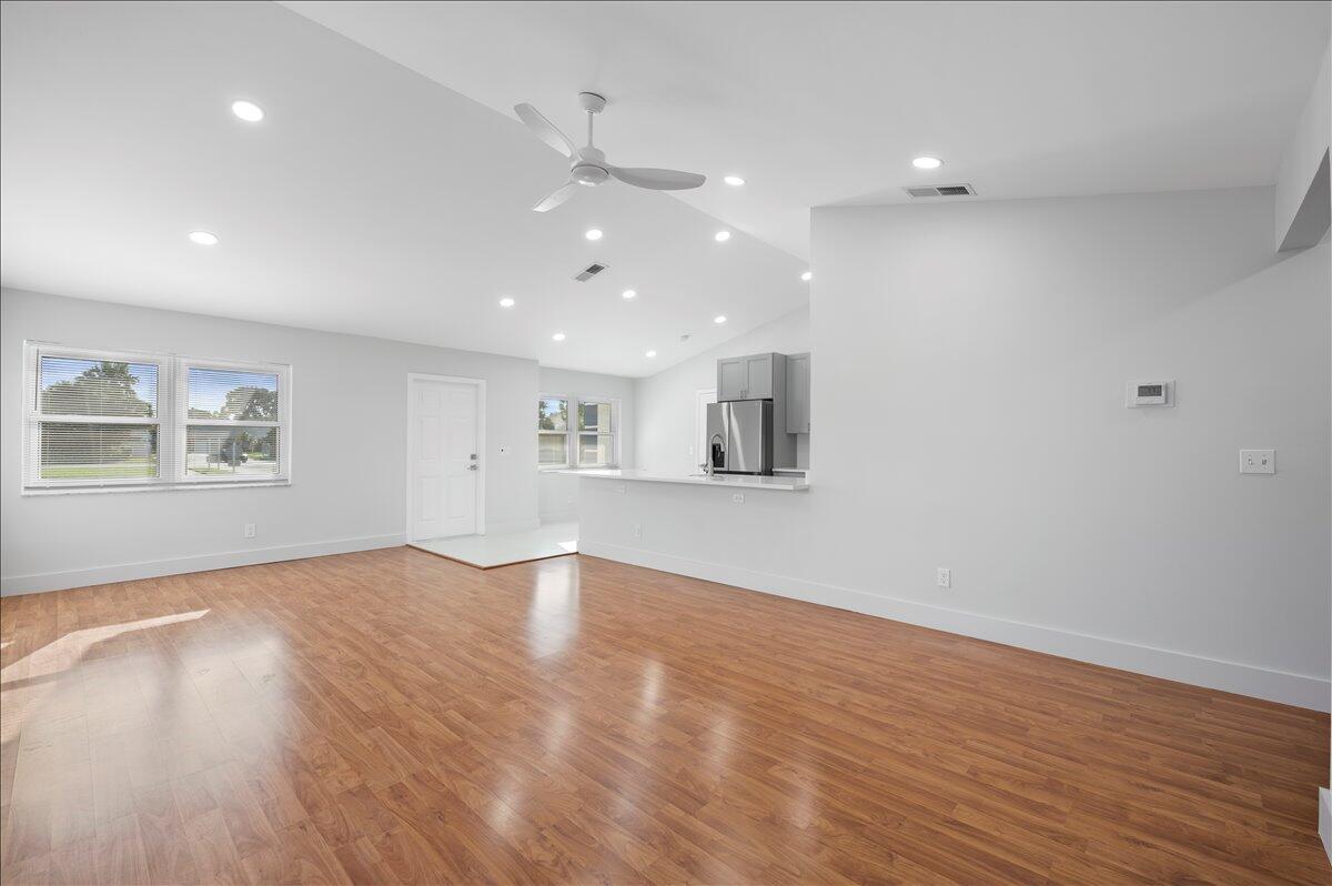 196 Raintree Trail Jupiter, FL 33458 - Photo 5 of 26 wooden floor in an empty room with a window