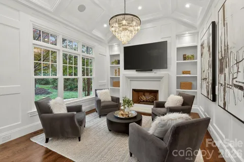 a living room with furniture fireplace and a flat screen tv