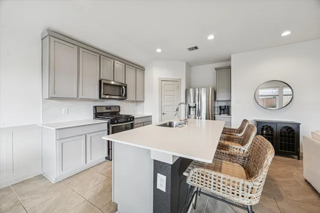 a kitchen with a stove and a refrigerator