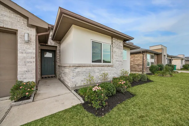 a front view of a house with garden