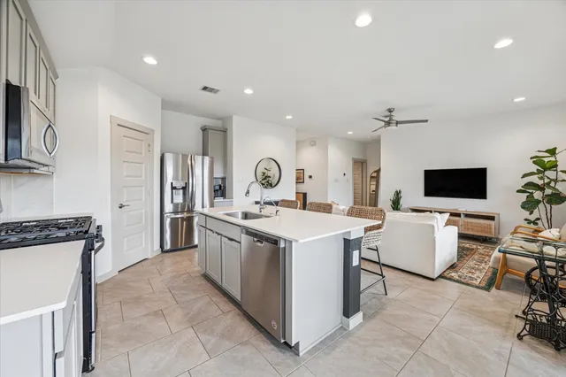 a kitchen with a sink and a stove top oven
