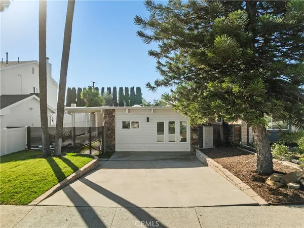 a view of a house with backyard and tree