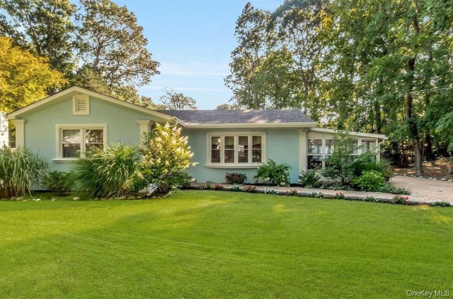 430 Grove Road Southold, NY 11971 - Photo 2 of 15 a front view of a house with a yard