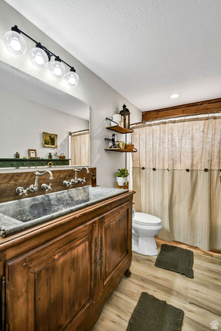 544 East 600 North, Unit 1 Joseph, UT 84739 - Photo 29 of 65 Distressed wood vanity featuring a trough sink, wall-mounted faucets, and a paneled wood backsplash