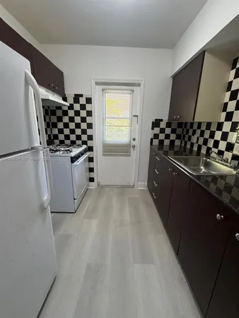 a kitchen with stainless steel appliances a refrigerator and a stove top oven