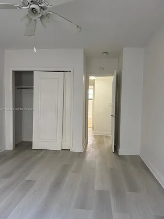 an empty room with a empty space and chandelier fan