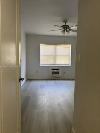 a view of an empty room and a window