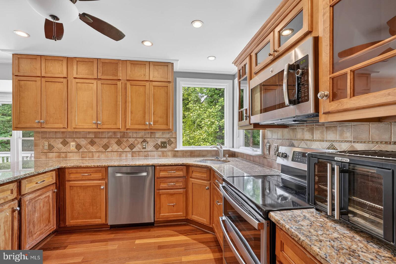 2108 Merrifields Drive Silver Spring, MD 20906 - Photo 13 of 69 a kitchen with a sink stove and cabinets