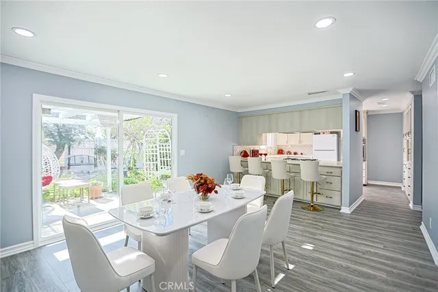 a dining room with furniture and a floor to ceiling window