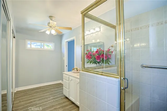a view of a hallway with wooden floor and chandelier