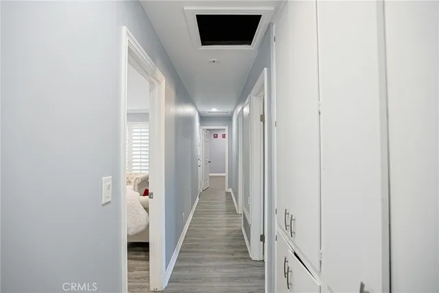 a view of a hallway with wooden floor