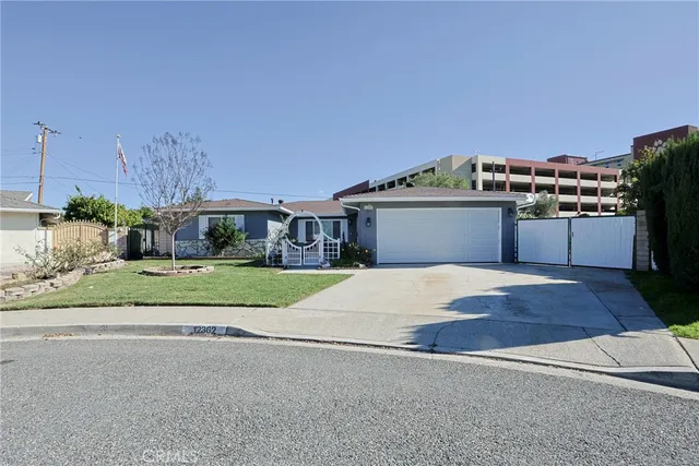 a front view of a house with a yard and a garage