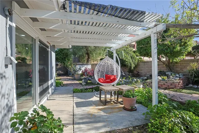 a view of a patio with table and chairs potted plants with wooden floor