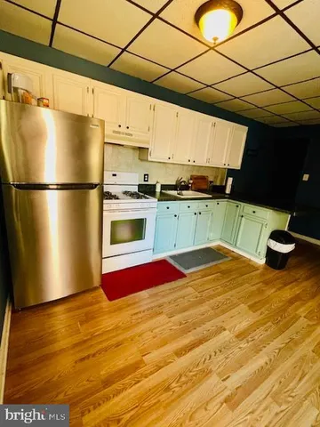 a kitchen with a refrigerator and a stove