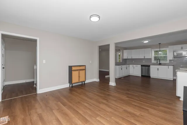 a view of kitchen with wooden floor and electronic appliances