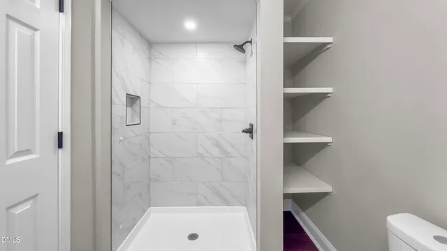 a bathroom with a shower and a toilet