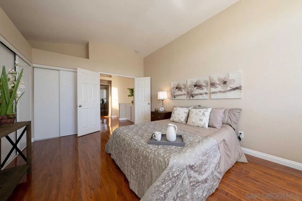 9765 Avenida Ricardo Spring Valley, CA 91977 - Photo 21 of 41 a bedroom with a bed and wooden floor