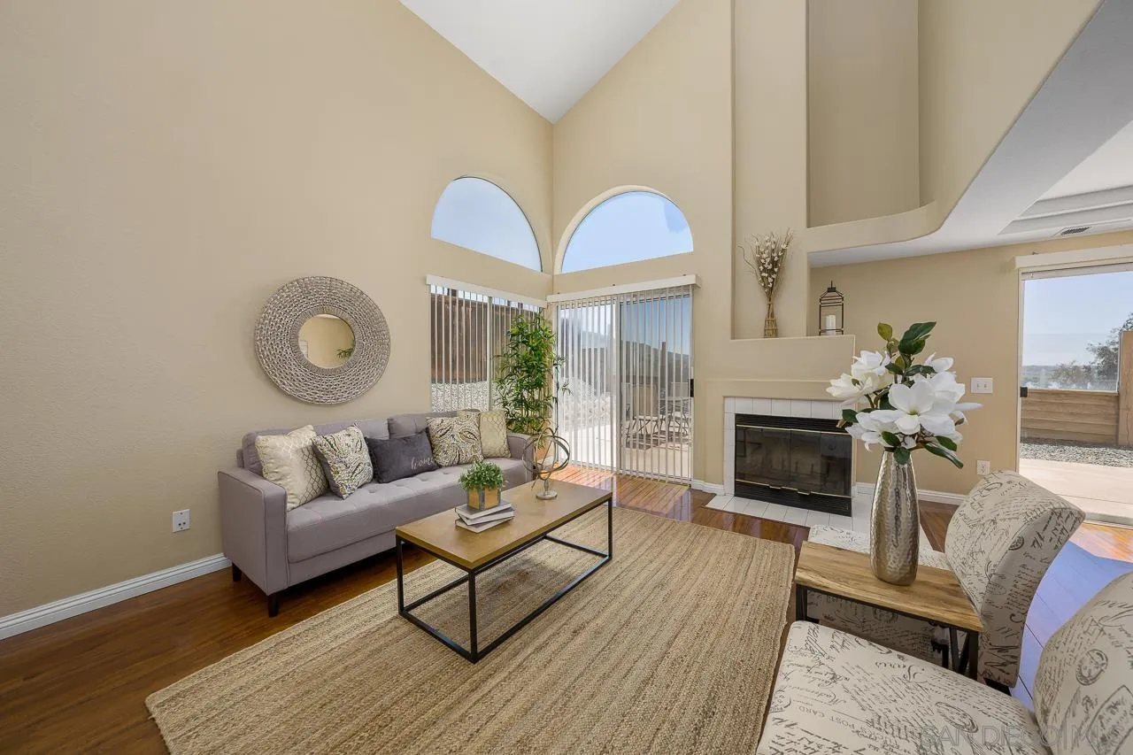 9765 Avenida Ricardo Spring Valley, CA 91977 - Photo 4 of 41 a living room with furniture a fireplace and a table