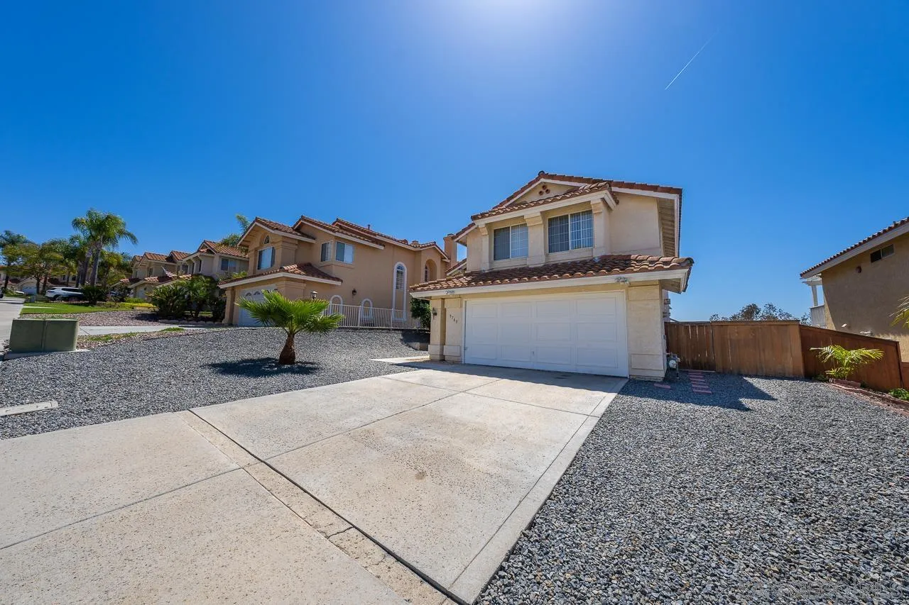 9765 Avenida Ricardo Spring Valley, CA 91977 - Photo 41 of 41 a front view of a house with a yard and garage