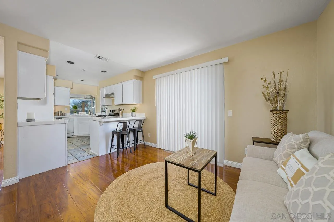 9765 Avenida Ricardo Spring Valley, CA 91977 - Photo 9 of 41 a living room with stainless steel appliances kitchen island granite countertop furniture and a fireplace